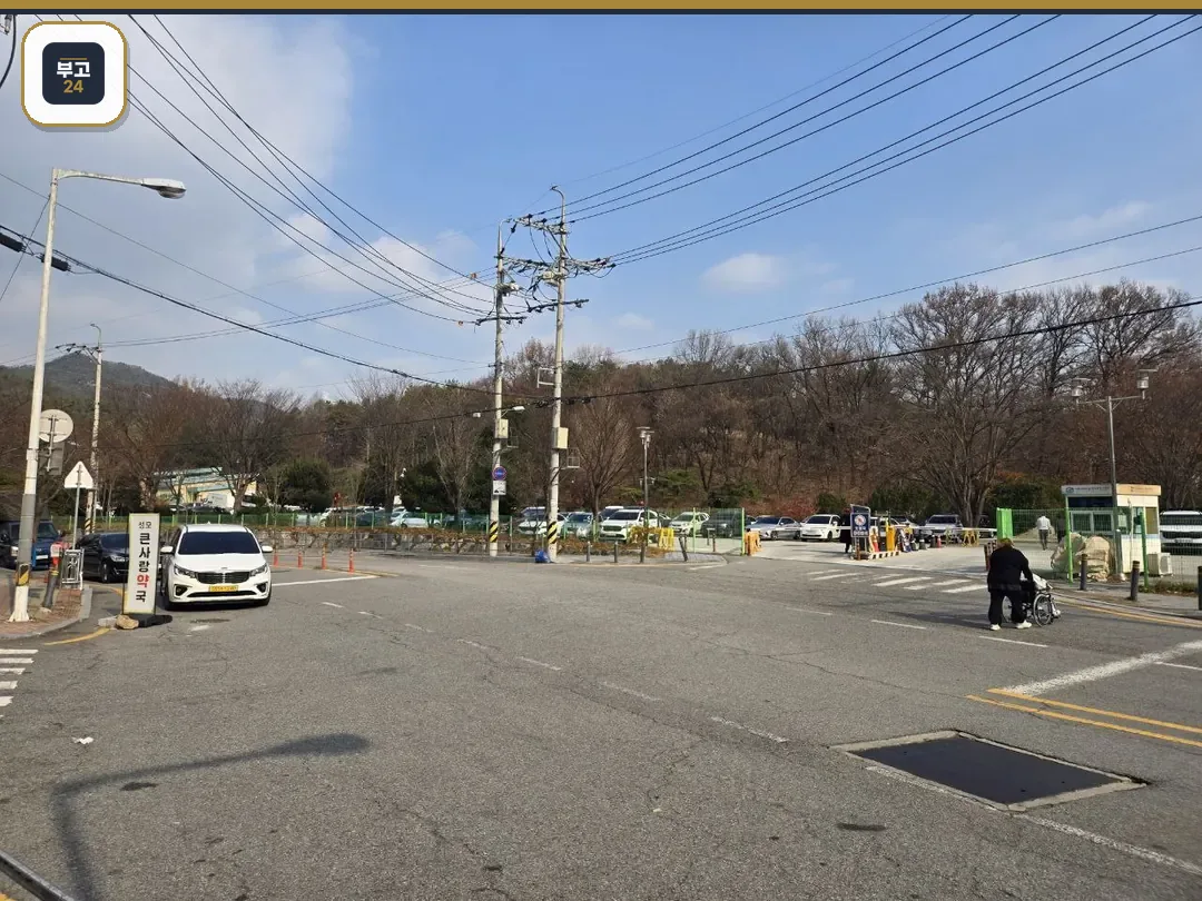 넓은 주차장과 주변 도로, 나무들이 보인다
