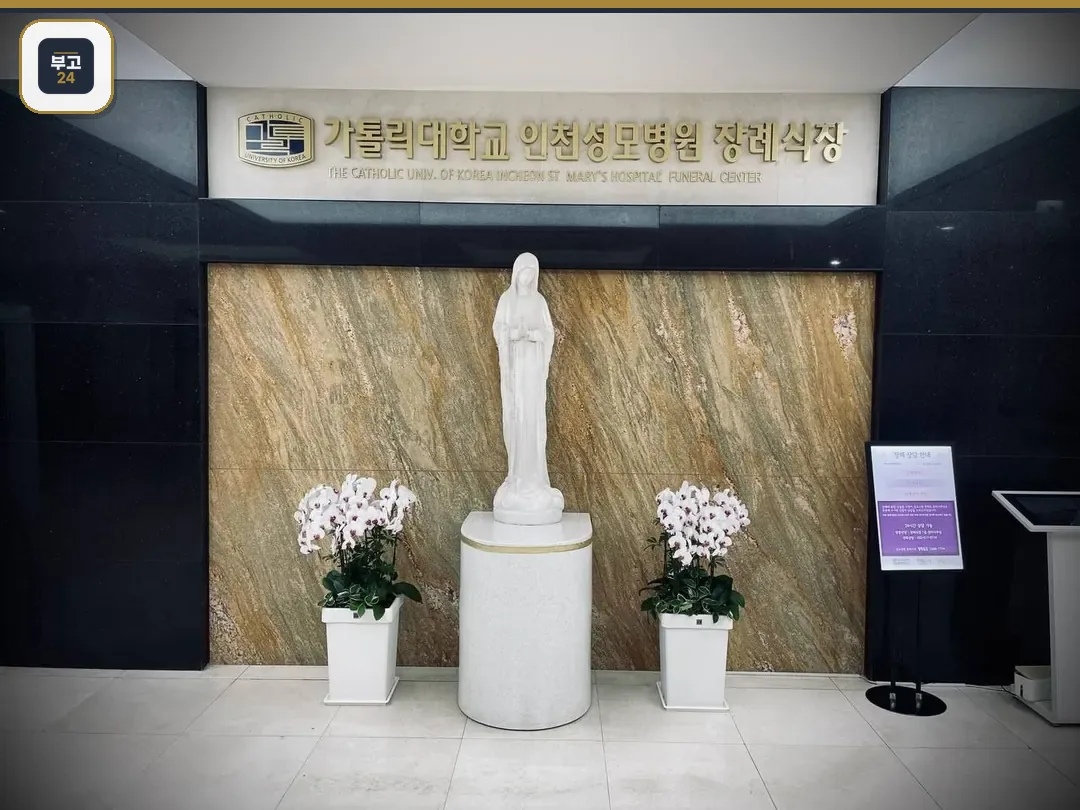 성모상과 금색 현판이 보이는 장례식장 로비